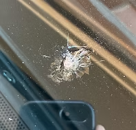 Close-up of windshield rock chip damage before repair